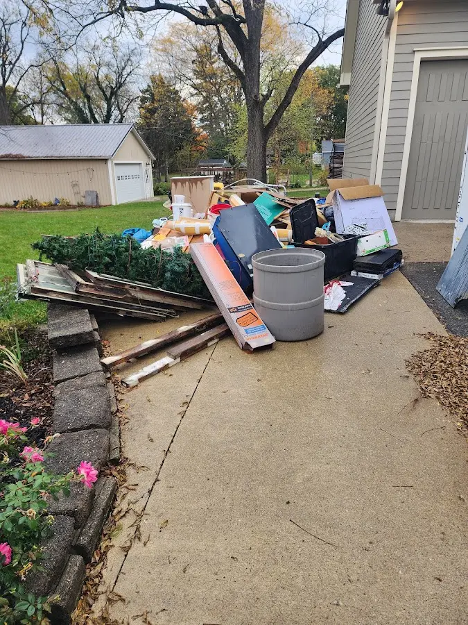 Dumpster being loaded with debris for 12 Yard Dumpster Rental in Linwood